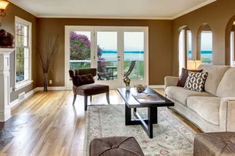 A living room with a couch, chair and table.