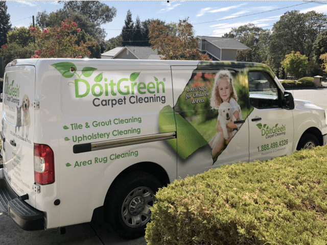 A white van with the words doitgreen carpet cleaning on it.